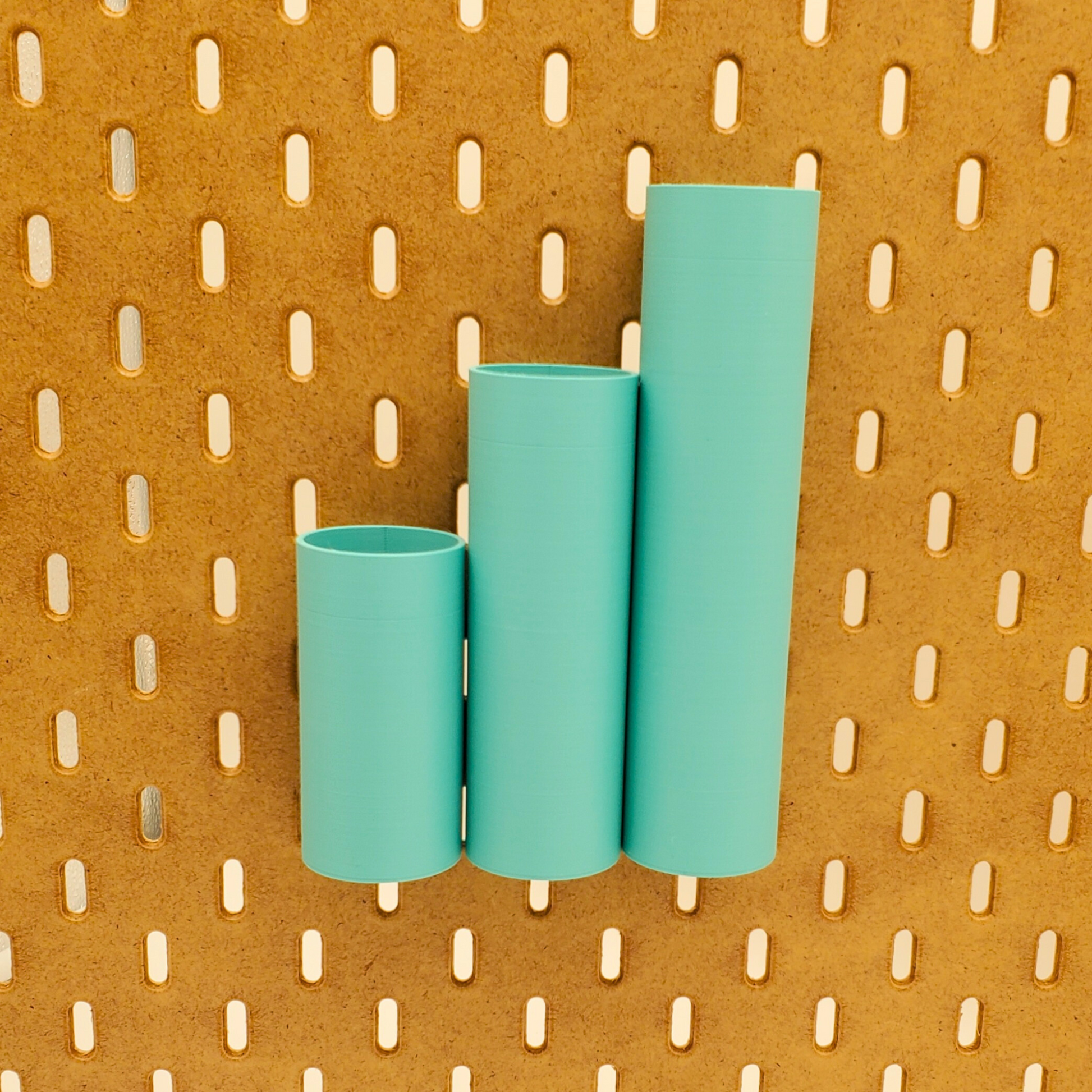 Small, Medium and Large Cylindrical bins on an IKEA Pegboard can be positioned next to each other and so all the tops line up