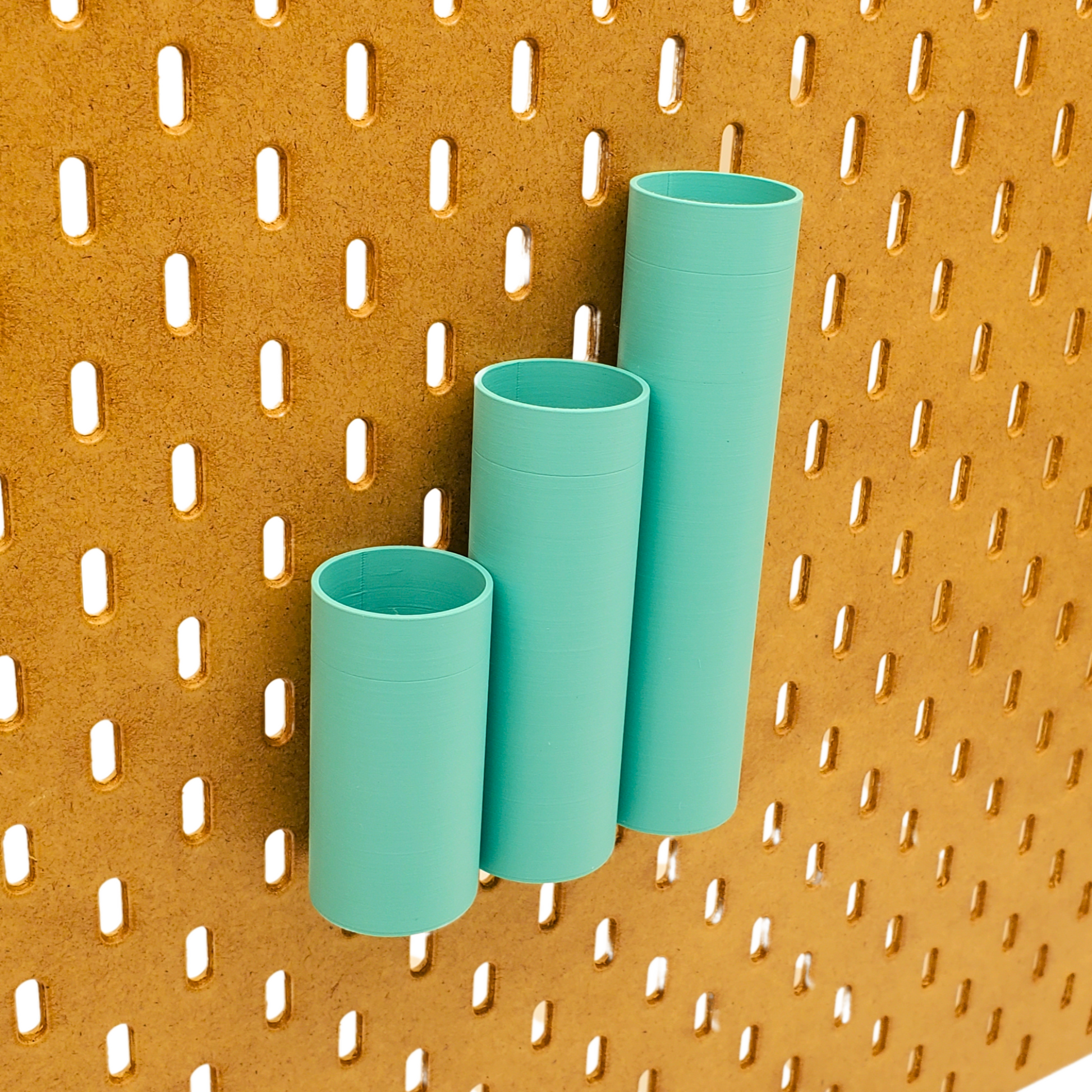 Small, Medium and Large Cylindrical bins on an IKEA Pegboard can be positioned next to each other and so all the Bottoms line up