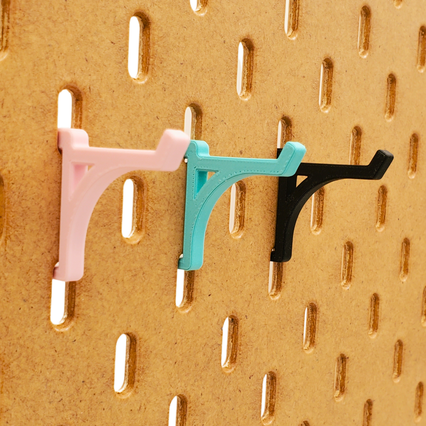 Charcoal Black, teal, and light pink IKEA SKADIS compatible platform hooks on skadis board