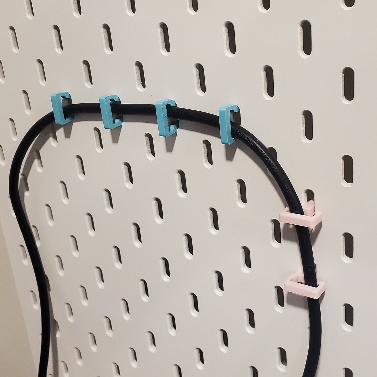 Light Pink Vertical Clips on the Right, Horizontal Wire clips in Teal on the left.