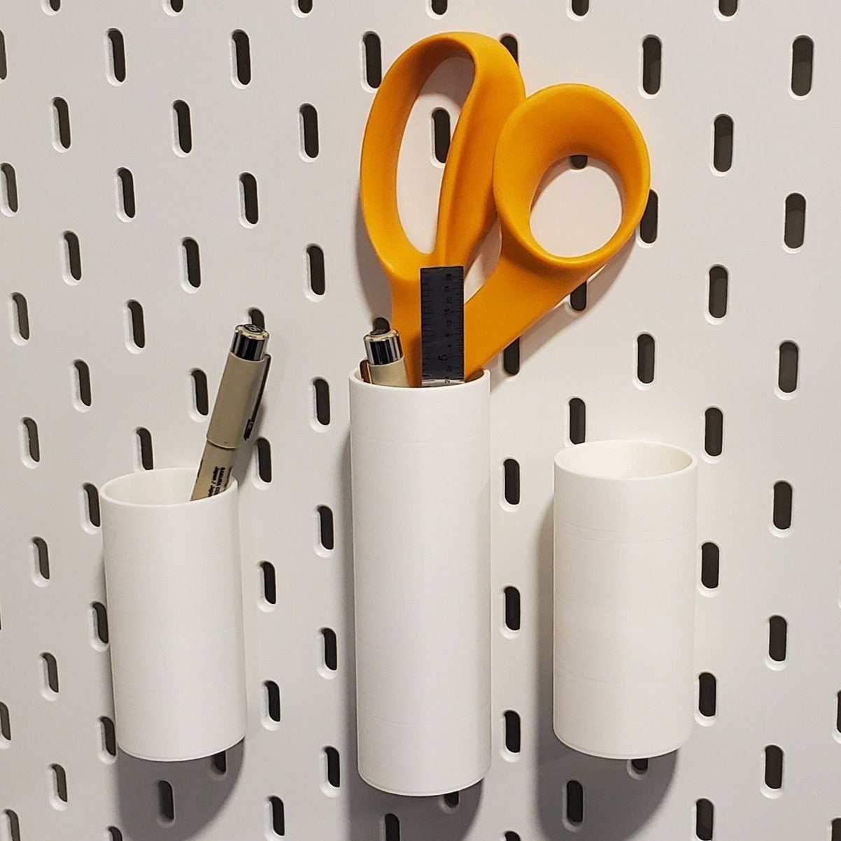 Small and Medium Cotton White Zip tie storage on a white pegboard